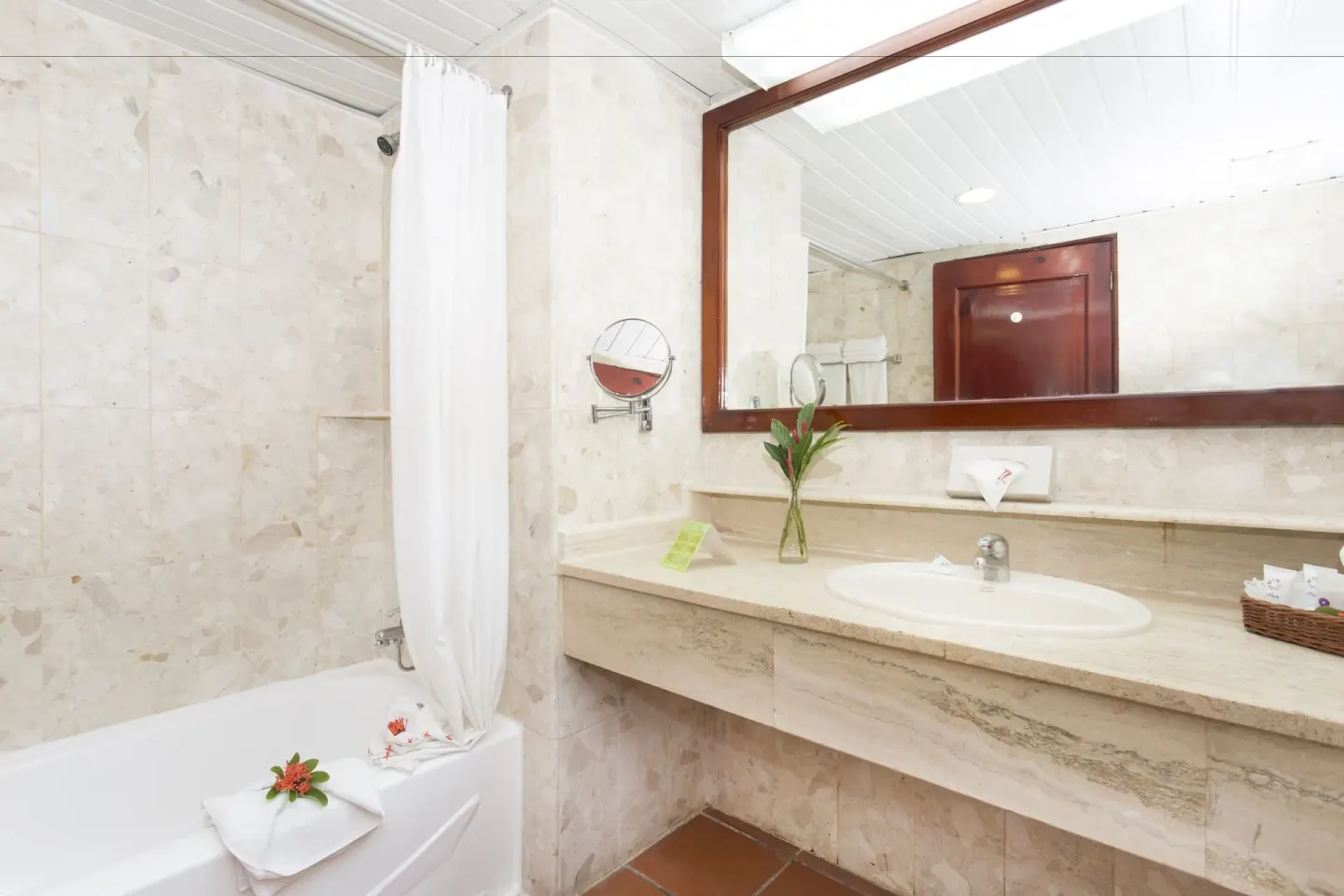 Guest bathroom vanity and tub with white shower curtain at Marien Puerto Plata.