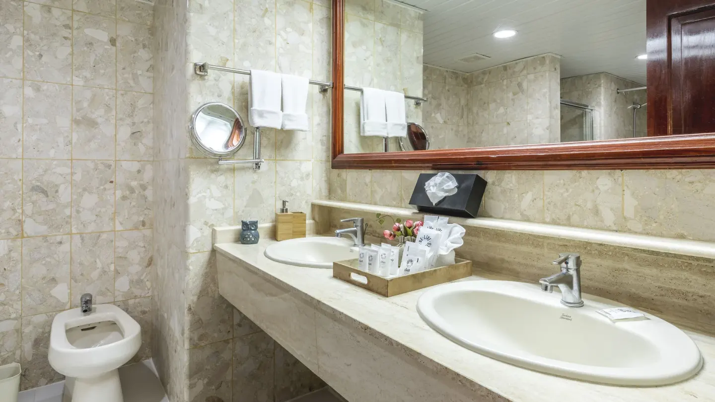 Double-sink bathroom vanity with bidet and amenities at Marien Puerto Plata.
