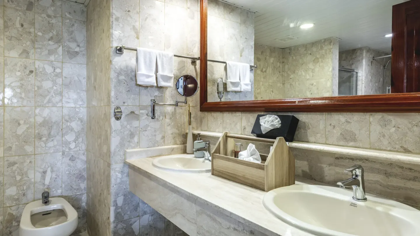 Double vanity bathroom with bidet, towels and mirror at Marien Puerto Plata.