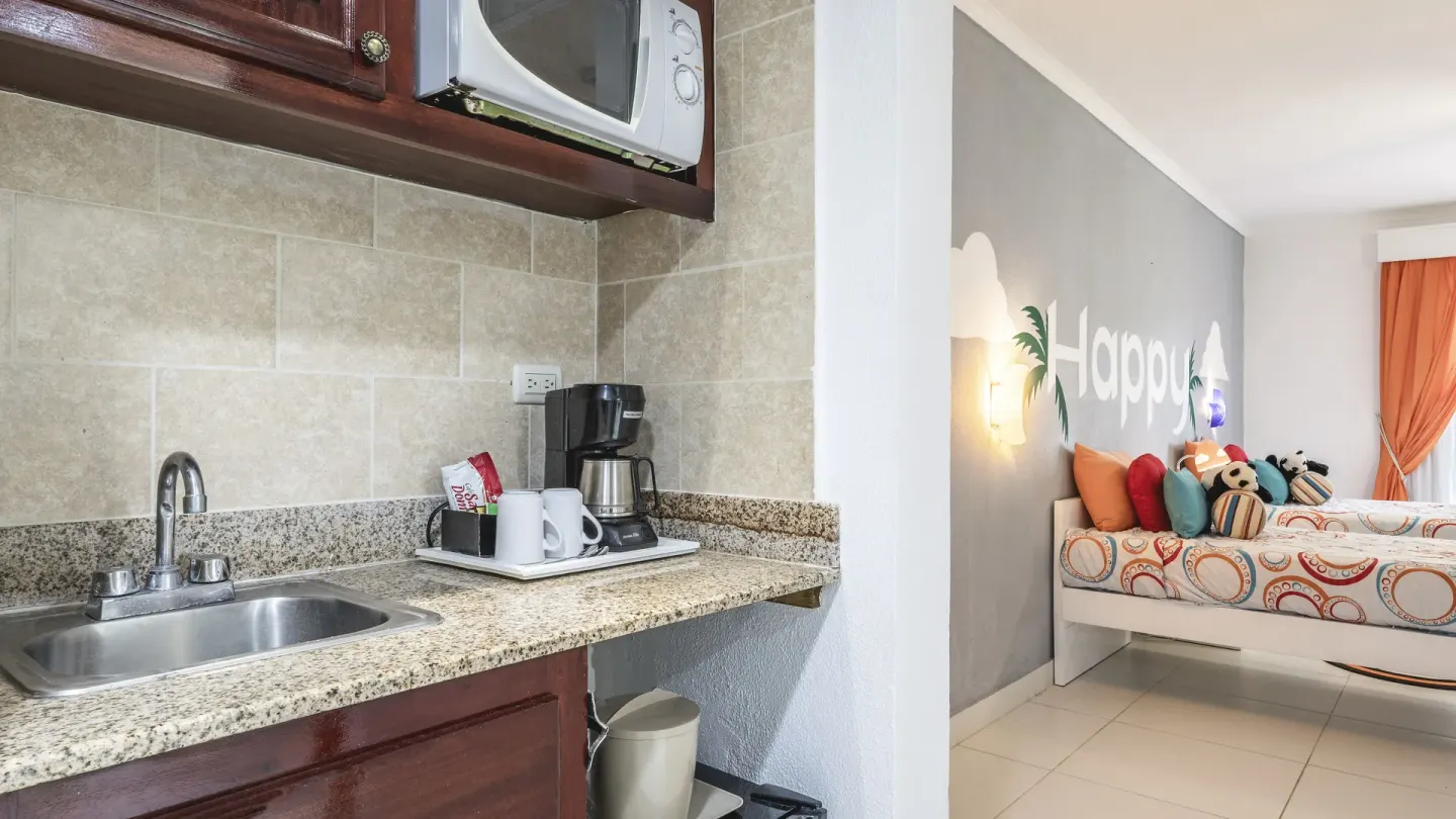 Suite kitchenette with sink, microwave, coffeemaker, and kids' bed area at Marien Puerto Plata.