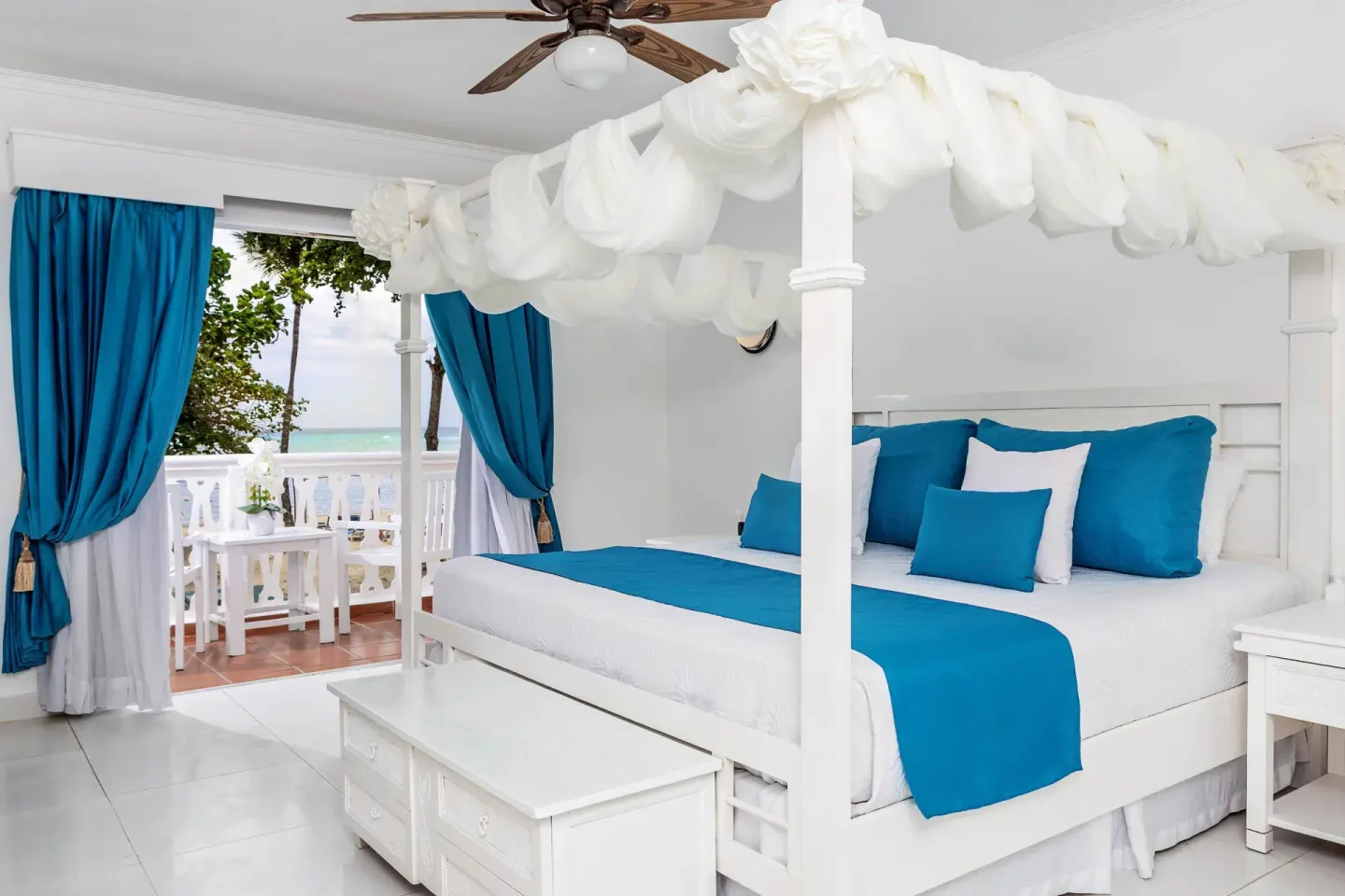 Oceanfront guest room with white canopy king bed and balcony at Marien Puerto Plata.