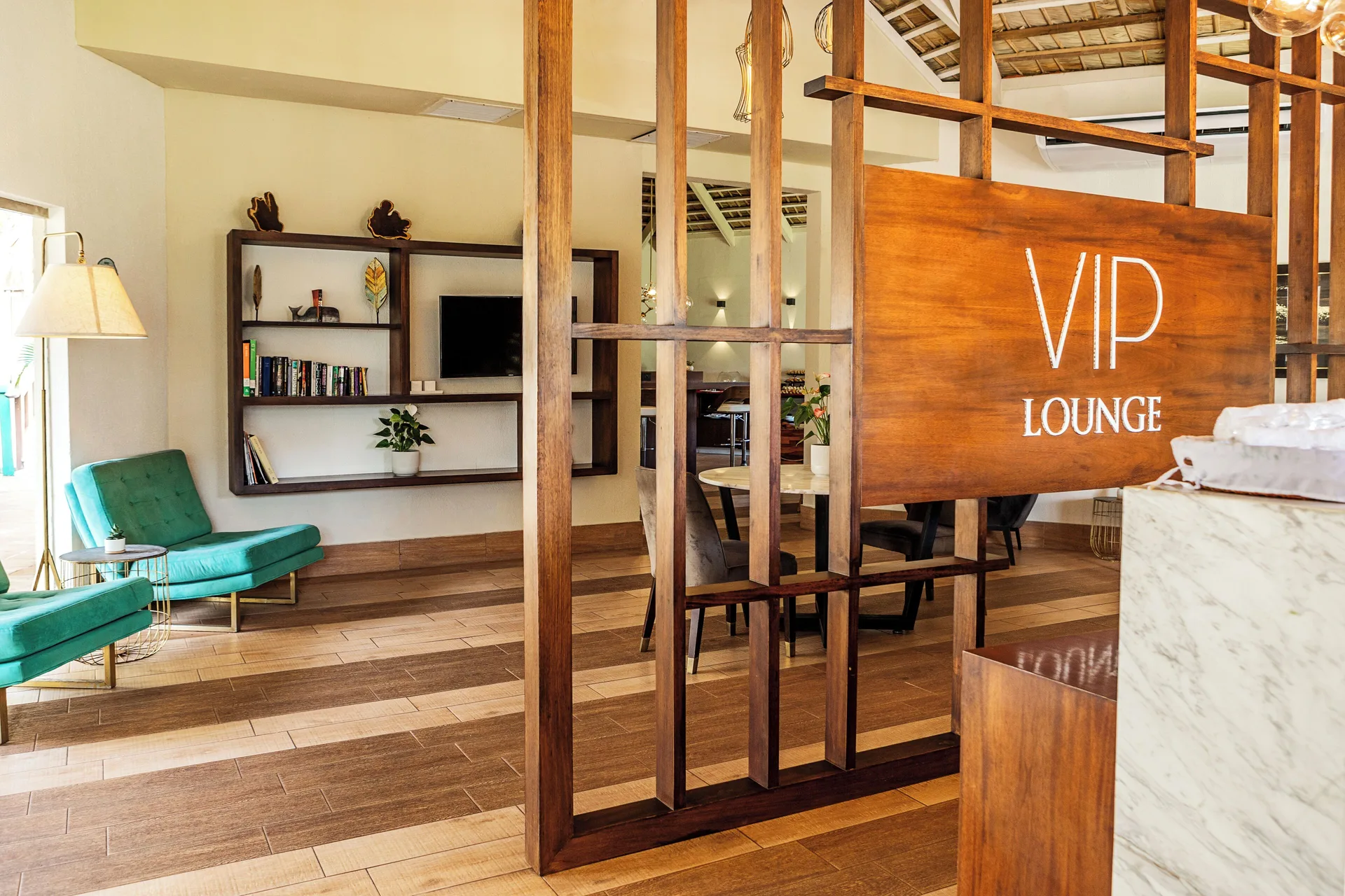 VIP lounge seating, bookshelves, and wood partition at Marien Puerto Plata.