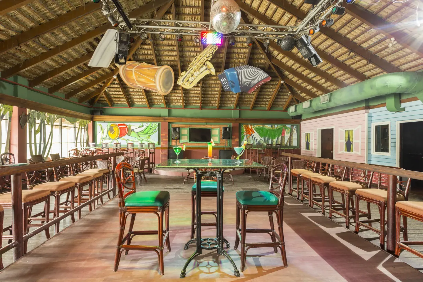 Dance bar tables, stools, lights, and hanging instrument decor at Marien Puerto Plata.