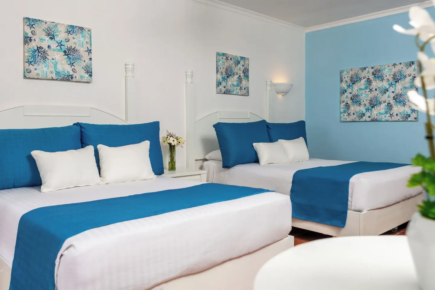Deluxe Room Garden View two double beds with blue accents at Marien Puerto Plata.