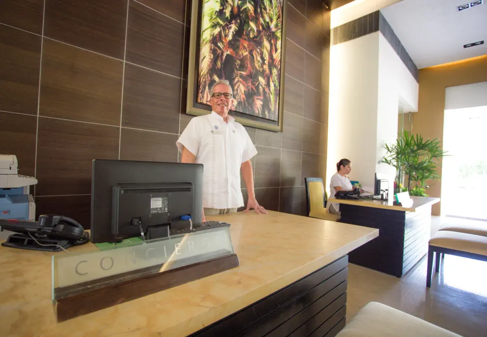 Concierge desk with staff and seating at Marival Distinct World Spa.
