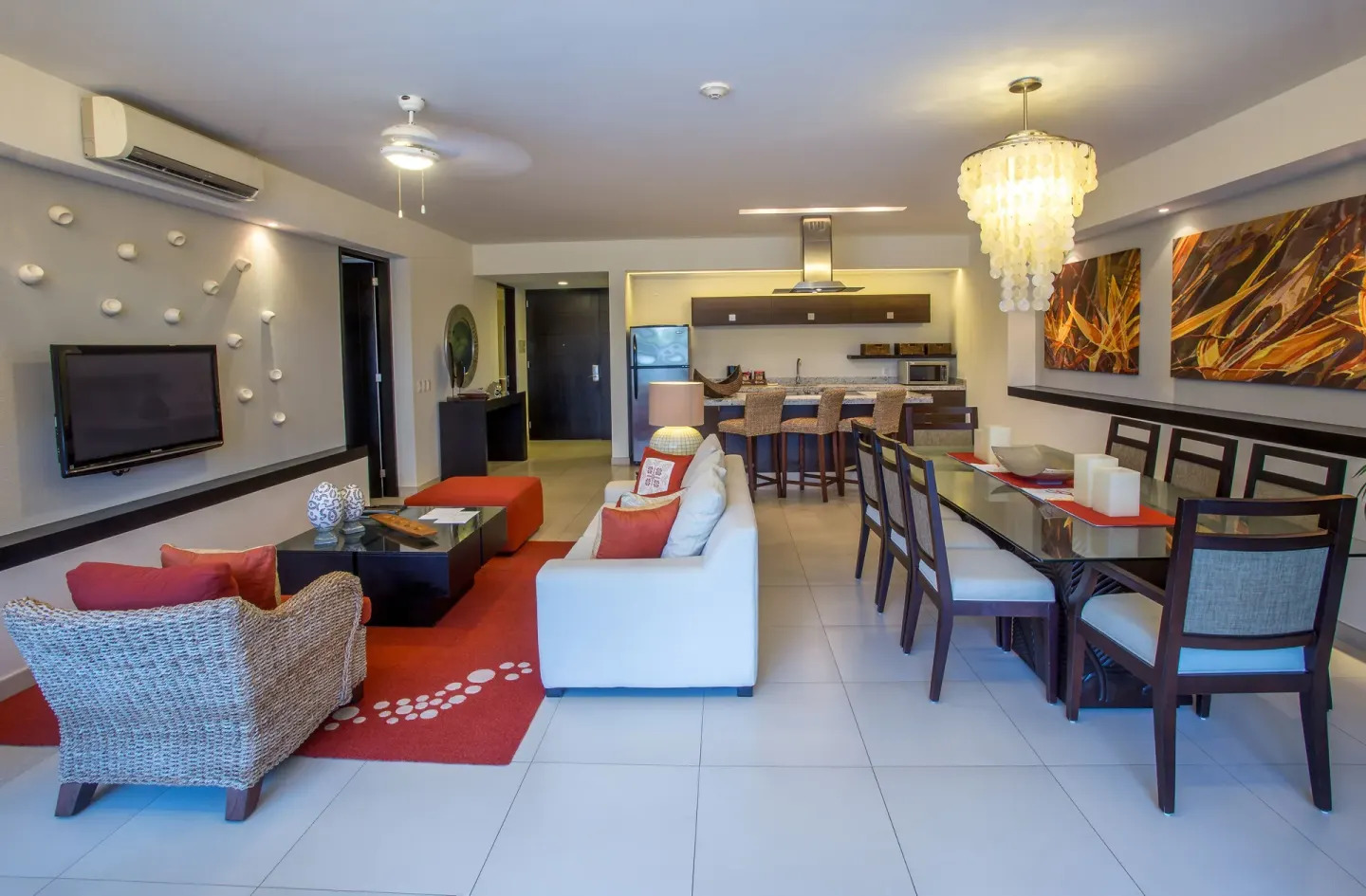 Open-plan suite living room with dining table and kitchen at Marival Distinct World Spa.