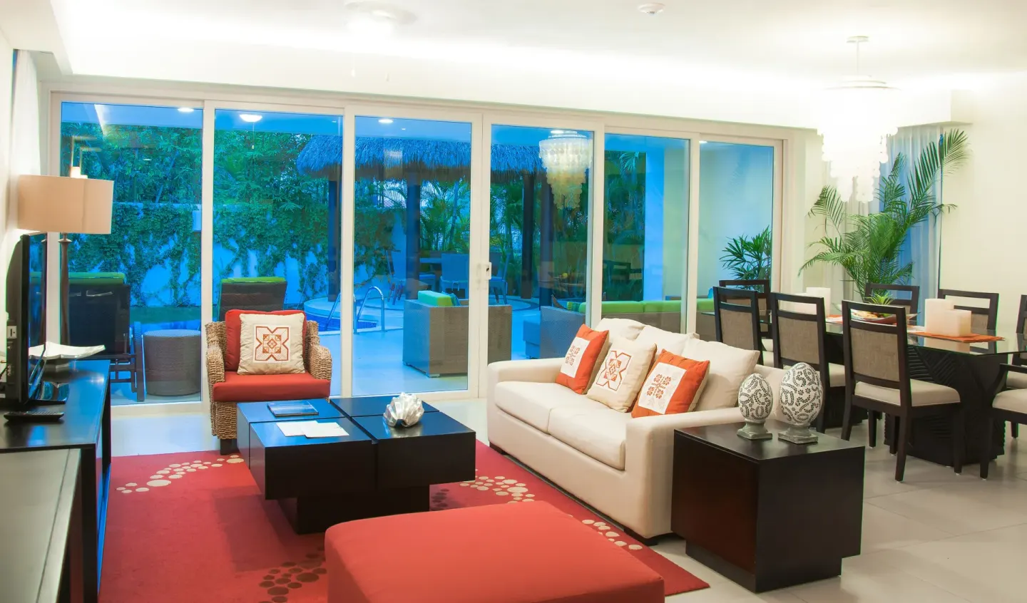 Suite living and dining room with sliding doors to a patio at Marival Distinct World Spa.