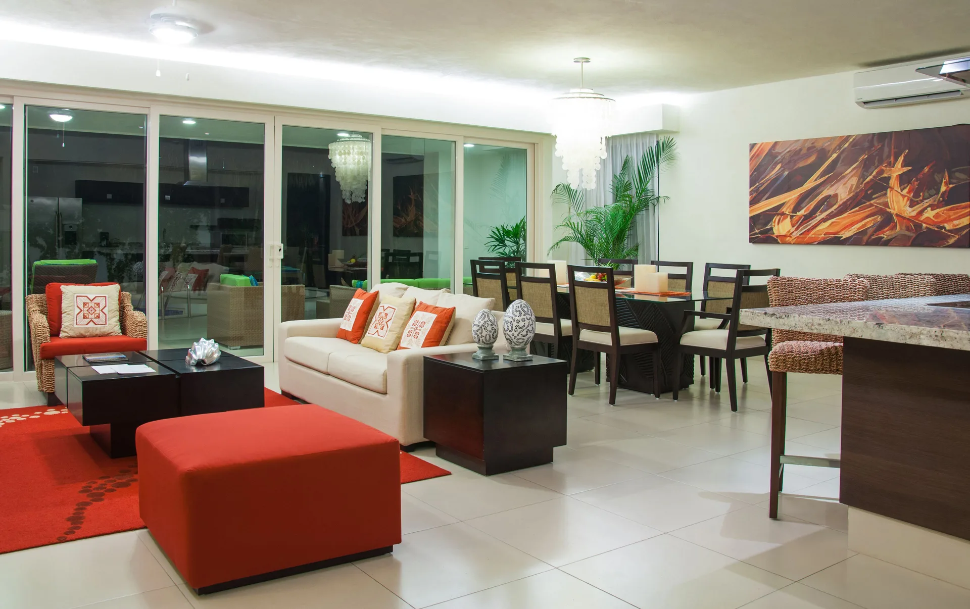Open living and dining suite with sofa and kitchen counter at Marival Distinct World Spa.