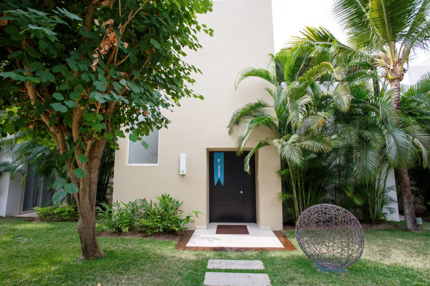 Tropical garden entrance to a guest building at Marival Distinct World Spa.