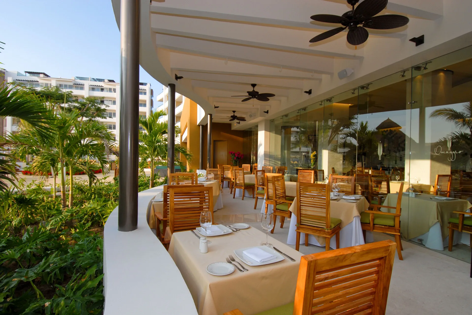 Omaggio terrace dining with set tables and garden views at Marival Distinct World Spa.