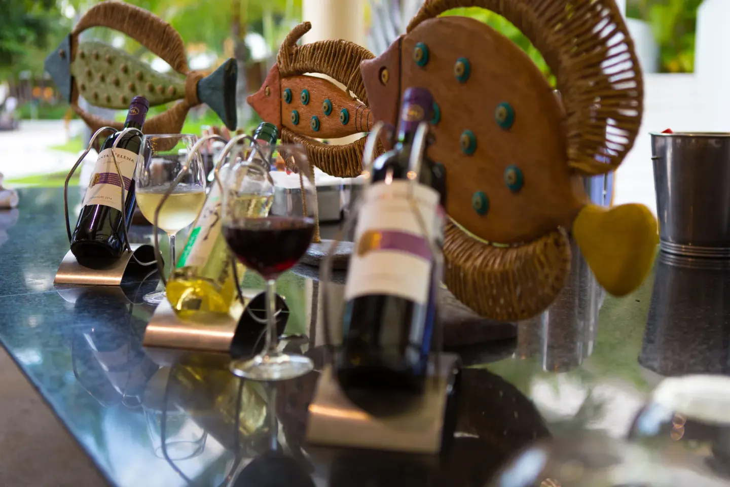 Wine tasting setup with glasses and decorative fish at Marival Distinct World Spa.