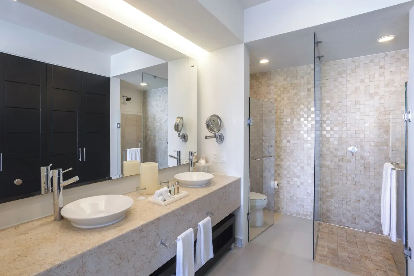 One-Bedroom Ocean View Suite bathroom with double sinks at Marival Distinct World Spa.