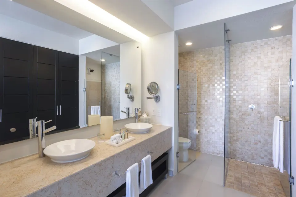 One-Bedroom Ocean View Suite bathroom with double sinks at Marival Distinct World Spa.
