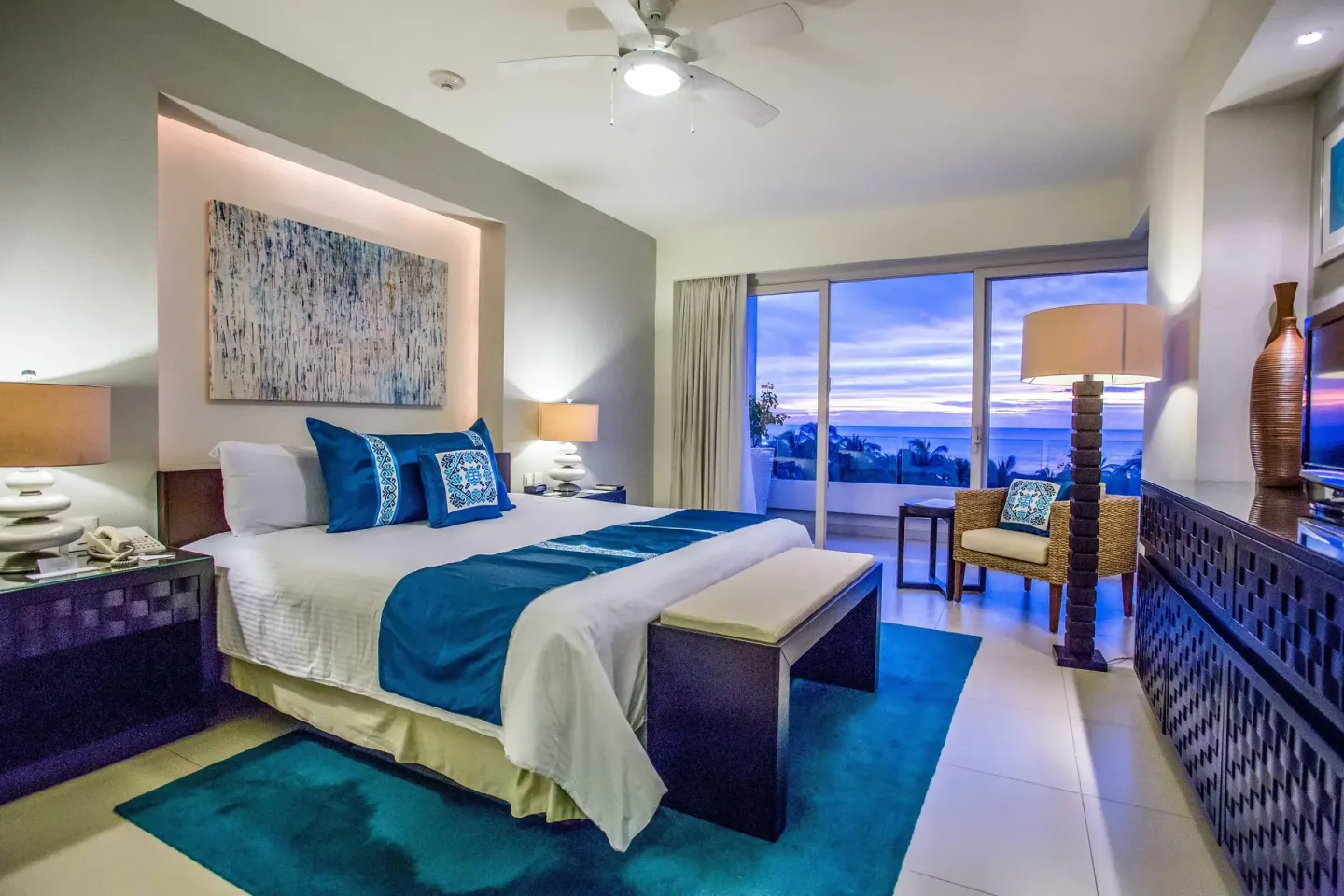 One-Bedroom Ocean View Suite king bedroom with balcony view at Marival Distinct World Spa.