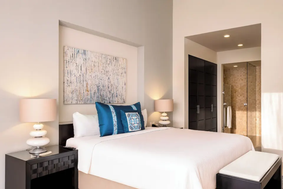One-Bedroom Penthouse king bed and open bathroom at Marival Distinct World Spa.