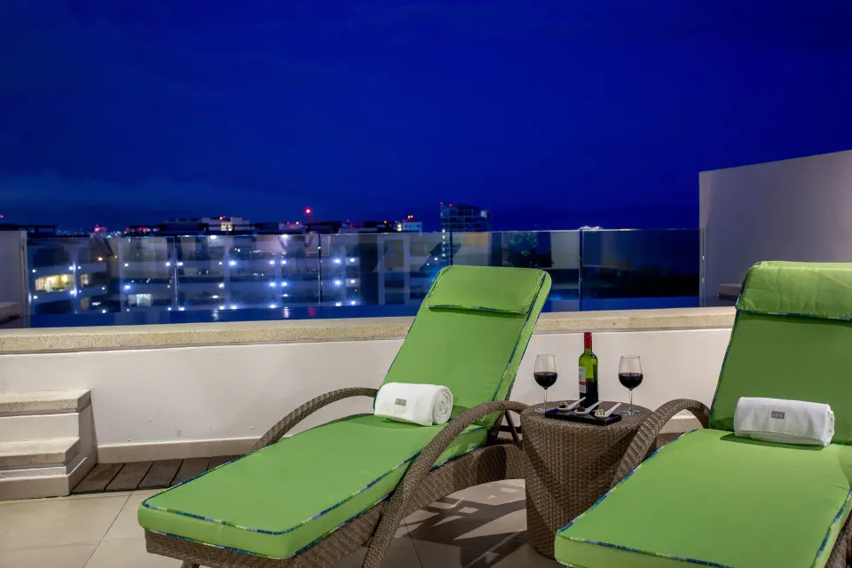 One-Bedroom Penthouse terrace loungers at night at Marival Distinct World Spa.