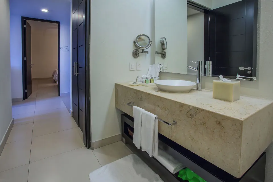 Bathroom vanity and hallway in Three-Bedroom Suite 2 at Marival Distinct World Spa.