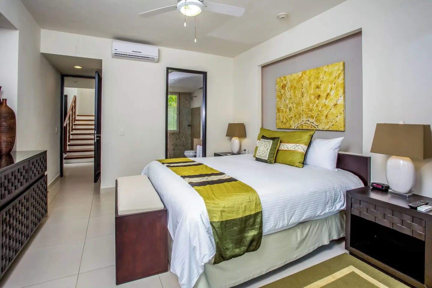 Three-Bedroom Villa bedroom with king bed and green accents at Marival Distinct World Spa.