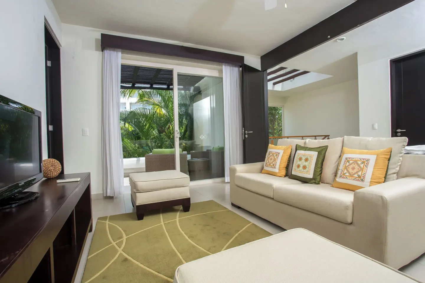 Three-Bedroom Villa lounge with sofa and terrace doors at Marival Distinct World Spa.