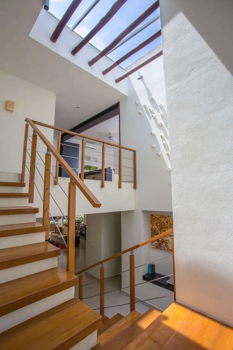 Three-Bedroom Villa staircase beneath a skylight at Marival Distinct World Spa.