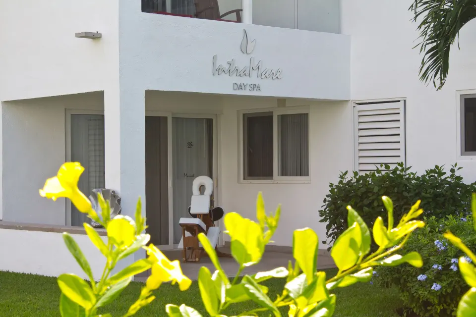 Spa entrance with garden flowers at Marival Emotions Resort.