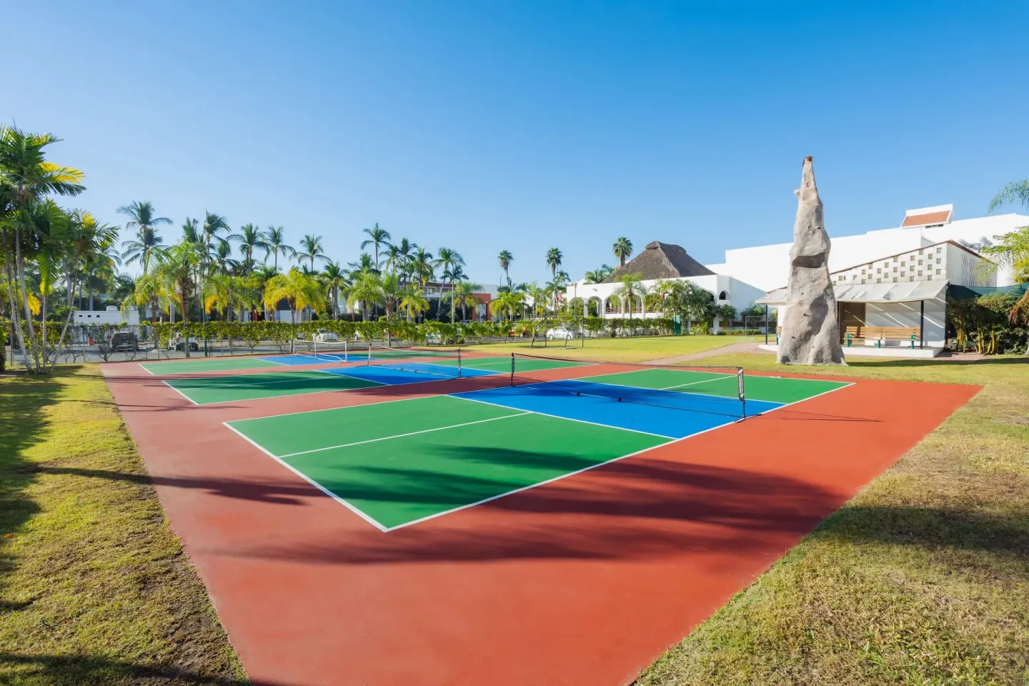 Colorful pickleball courts and climbing wall at Marival Emotions Resort.