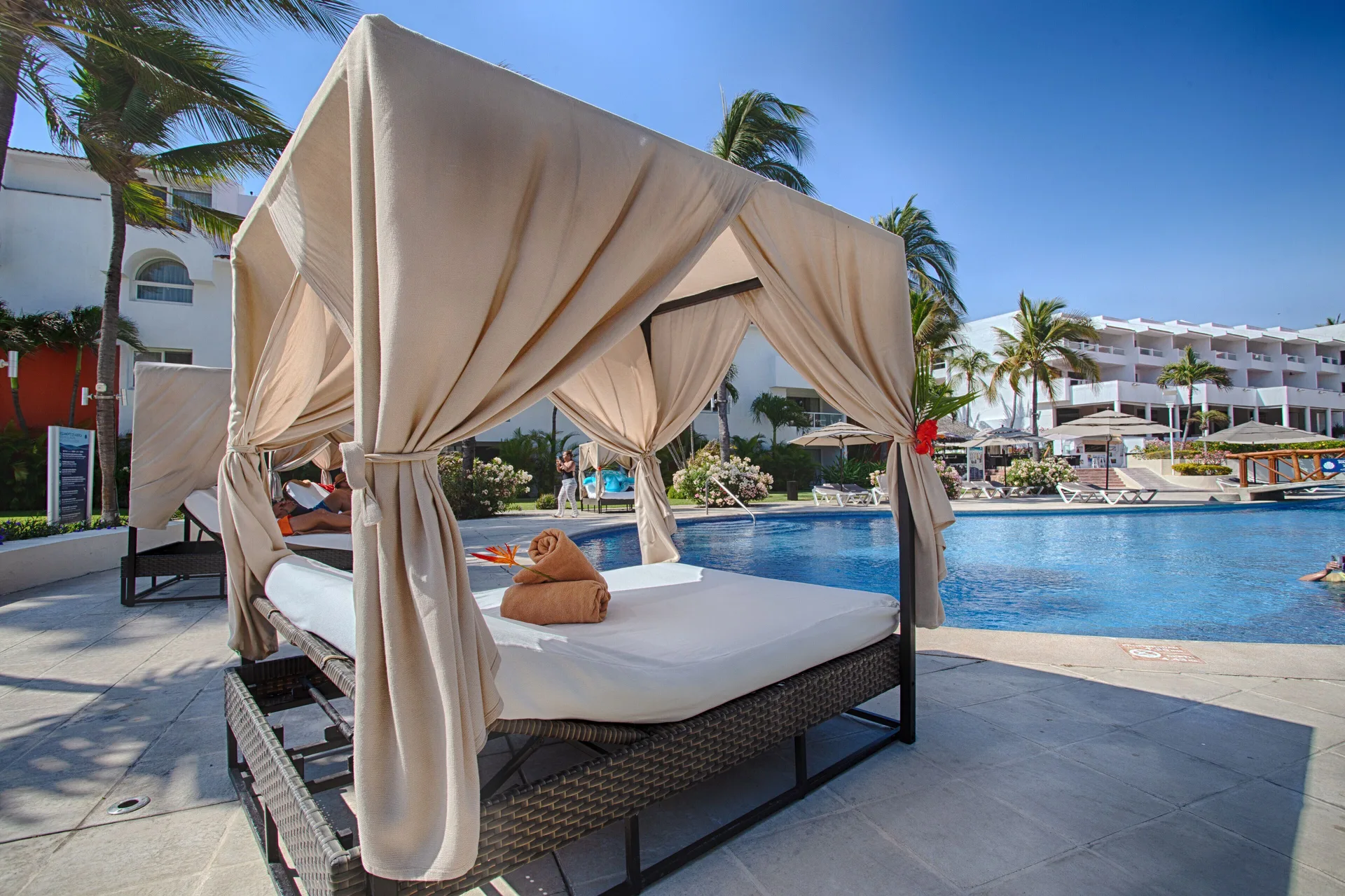 A poolside cabana faces the swimming pool at Marival Emotions Resort.