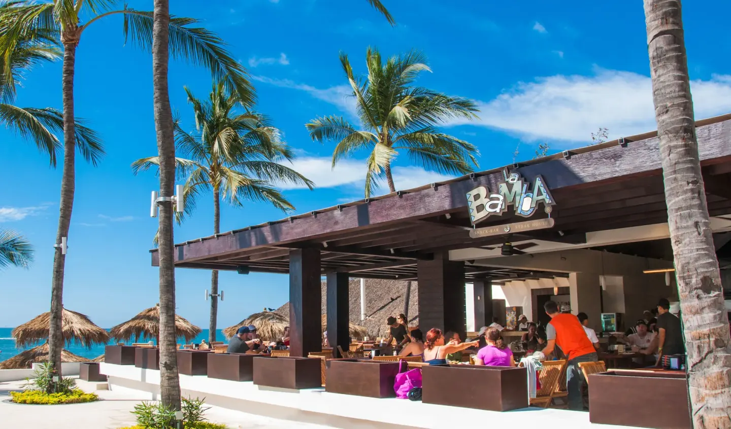 La Bamba oceanfront restaurant patio with palm trees at Marival Emotions Resort.