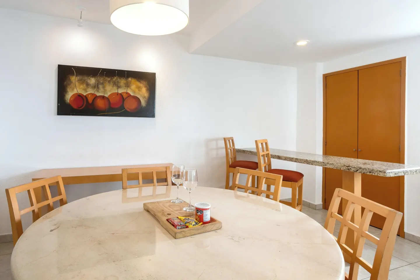 Suite dining area with round table and breakfast bar at Marival Emotions Resort.
