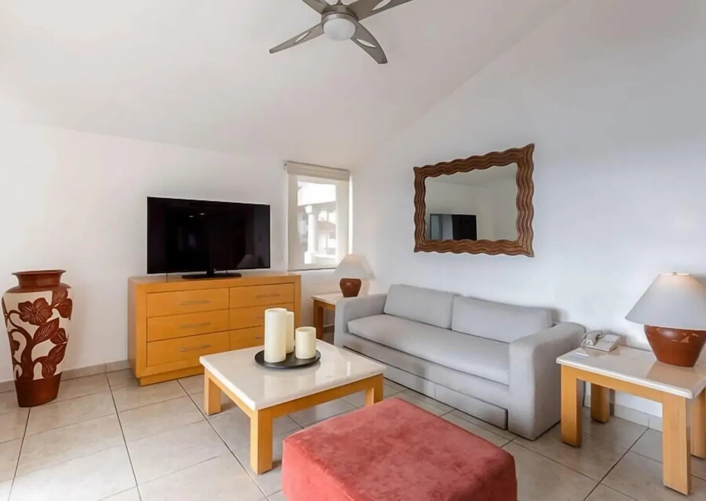 Suite living room with sofa, TV and coffee table at Marival Emotions Resort.