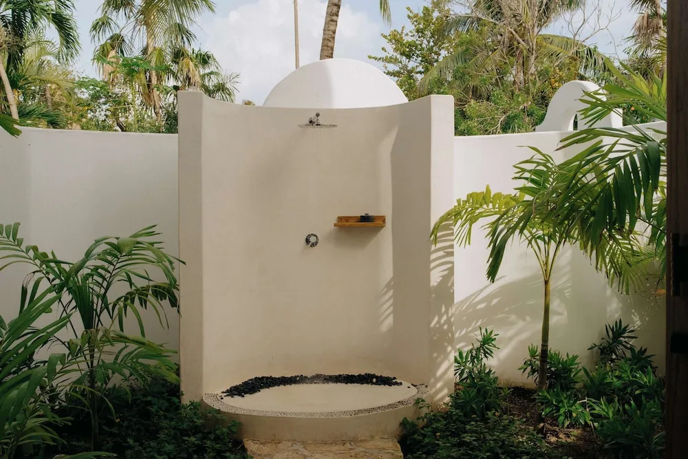 Garden outdoor shower enclosed by white walls at Maroma, Riviera Maya.