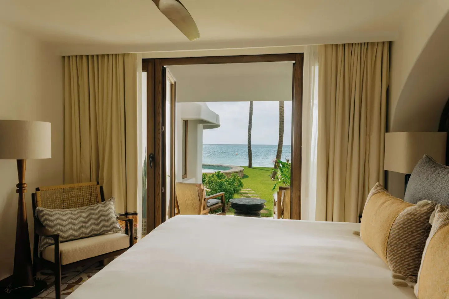 King bed facing open terrace doors and the ocean at Maroma, Riviera Maya.