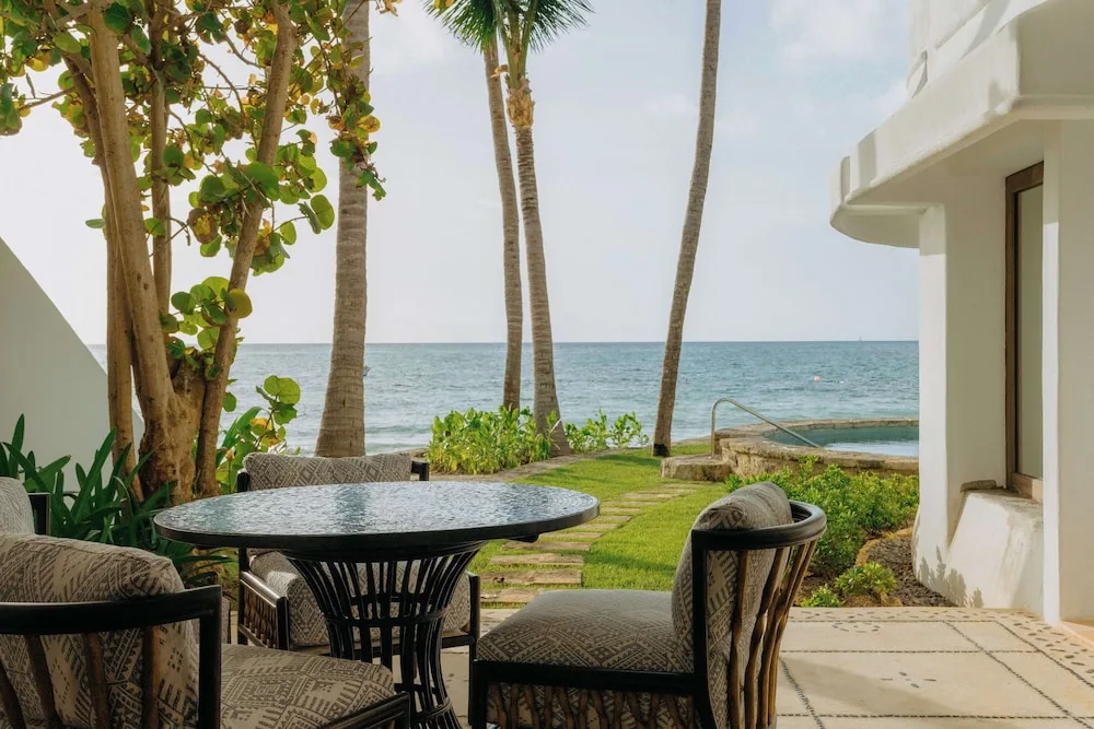 Private patio seating with palms and ocean view at Maroma, Riviera Maya.