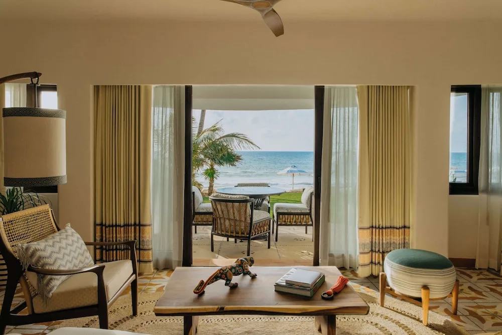 Suite sitting area with balcony seating and ocean view at Maroma, Riviera Maya.