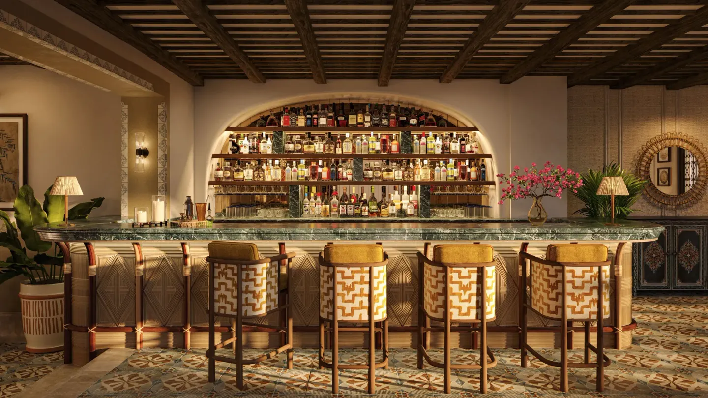 Bar with patterned stools and arched bottle shelving at Maroma, Riviera Maya.