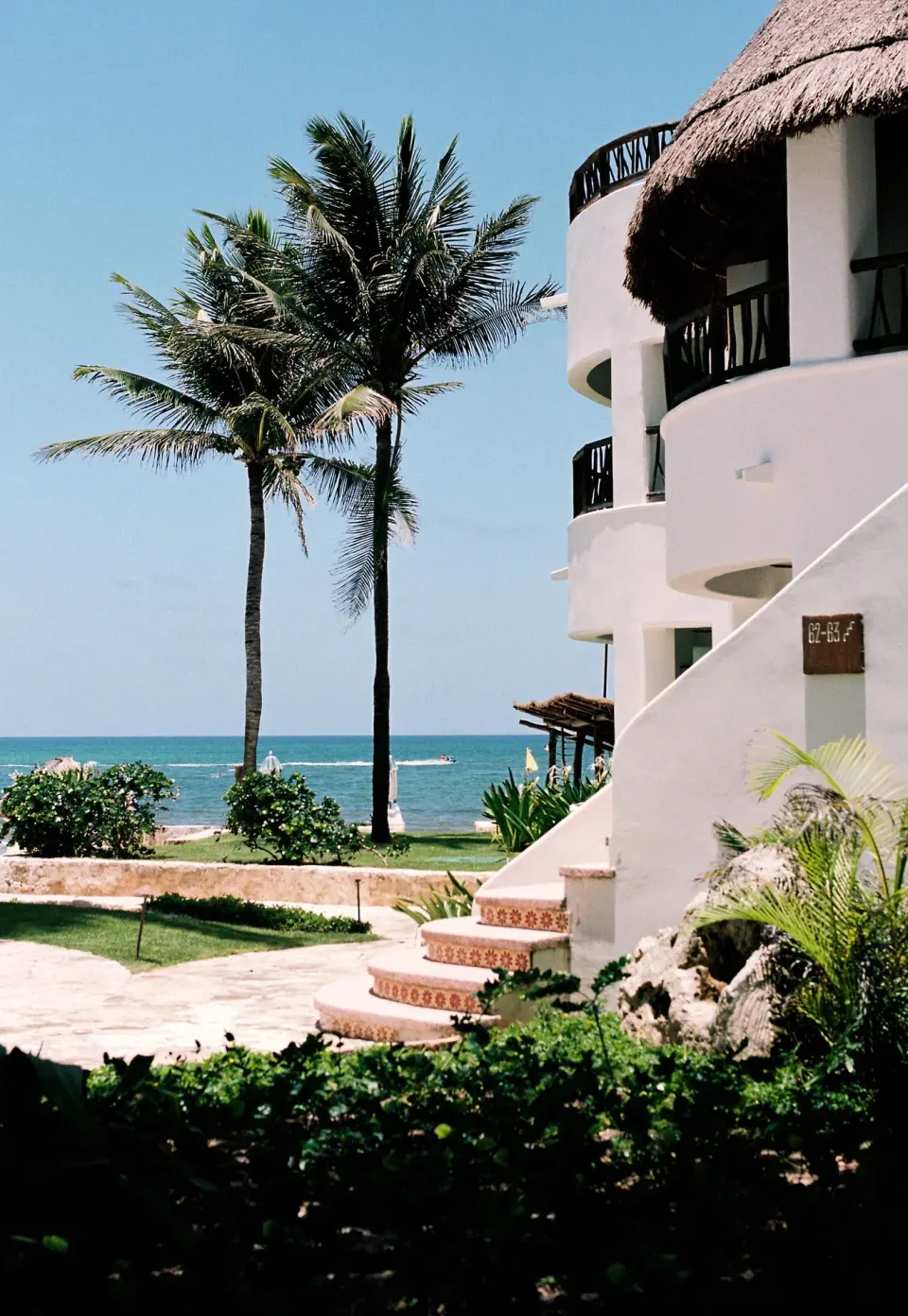Deluxe Ocean View Room exterior with palms and the Caribbean Sea at Maroma, Riviera Maya.