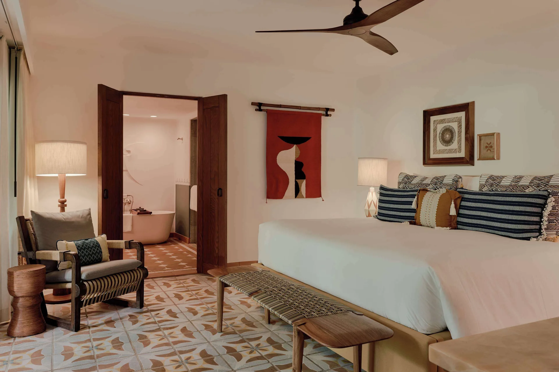 Garden View Premium Suite king bed at Maroma, Riviera Maya with seating and bath beyond.