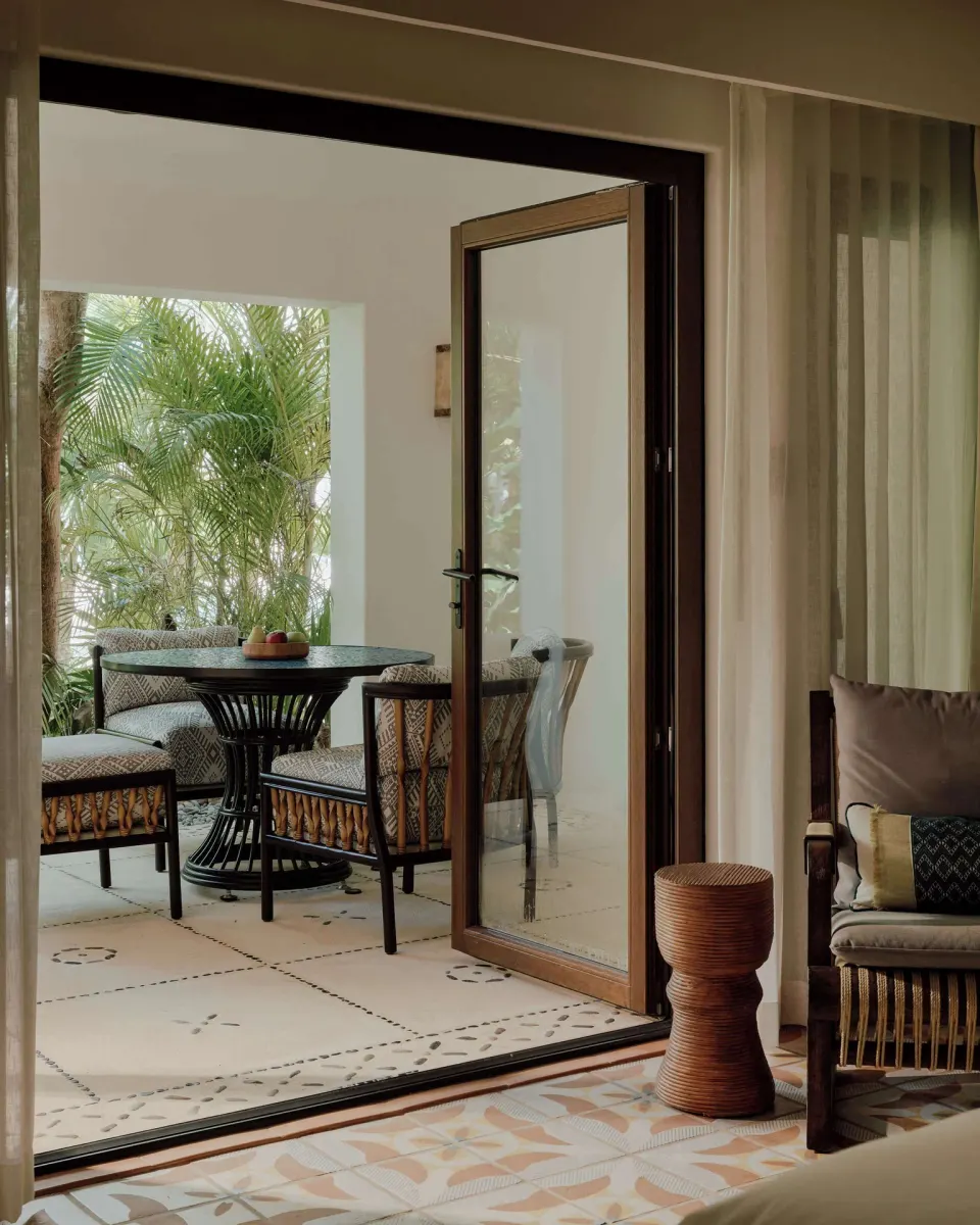 Garden View Premium Suite terrace seating at Maroma, Riviera Maya with palms outside.