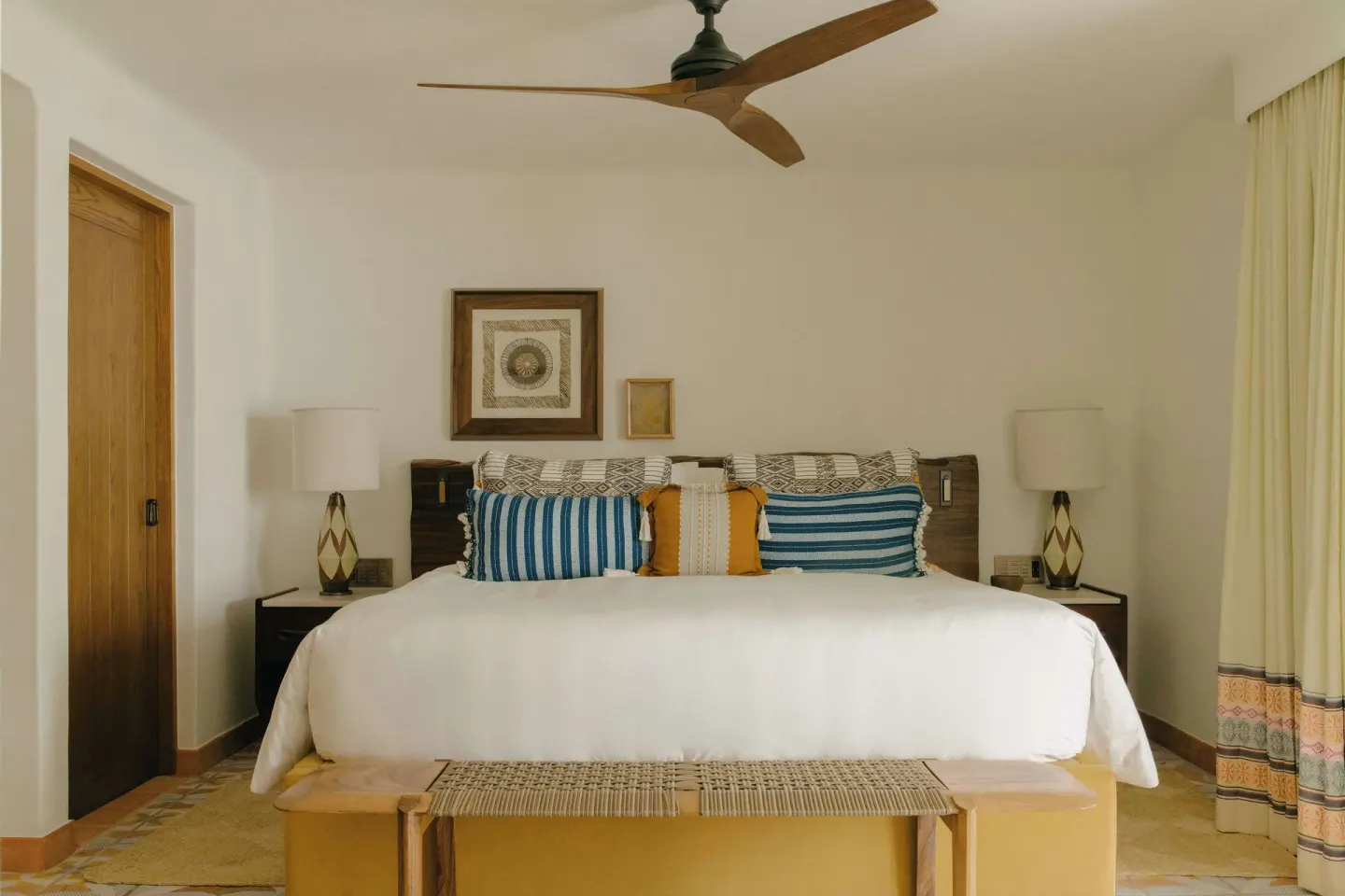 Junior Suite Garden View bed with striped pillows at Maroma, Riviera Maya.