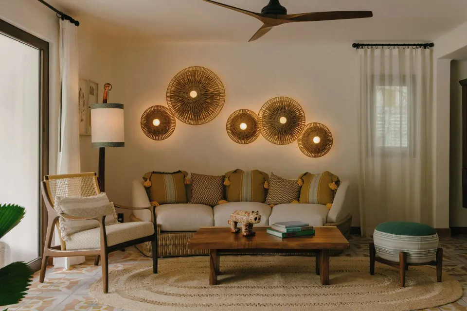 Junior Suite Garden View sitting area with sofa and woven wall lights at Maroma, Riviera Maya.