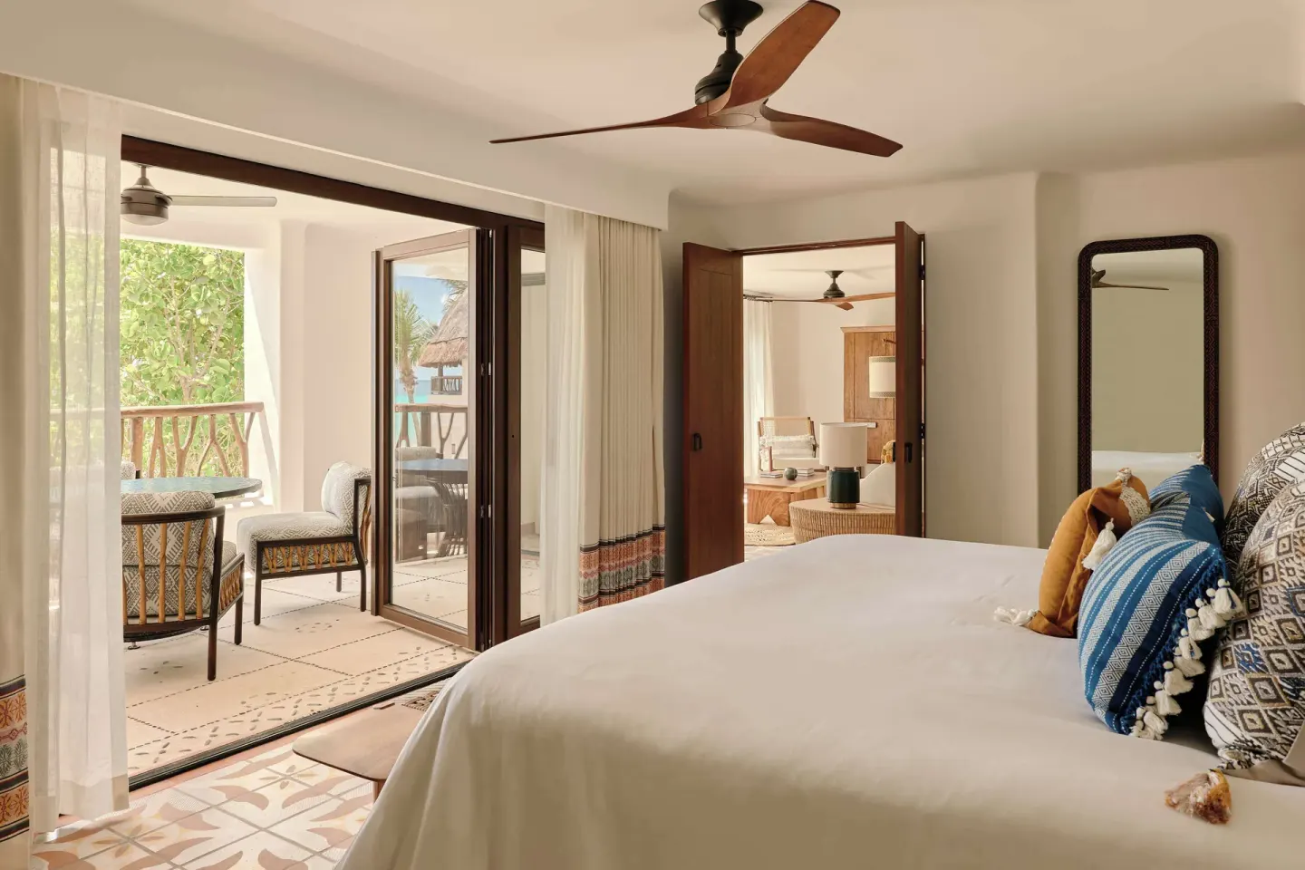 Ocean View Premium Suite king bed opening to a balcony at Maroma, Riviera Maya.