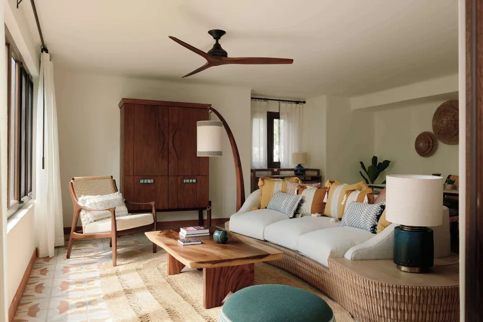 Ocean View Premium Suite living room with sofa and wood armoire at Maroma, Riviera Maya.