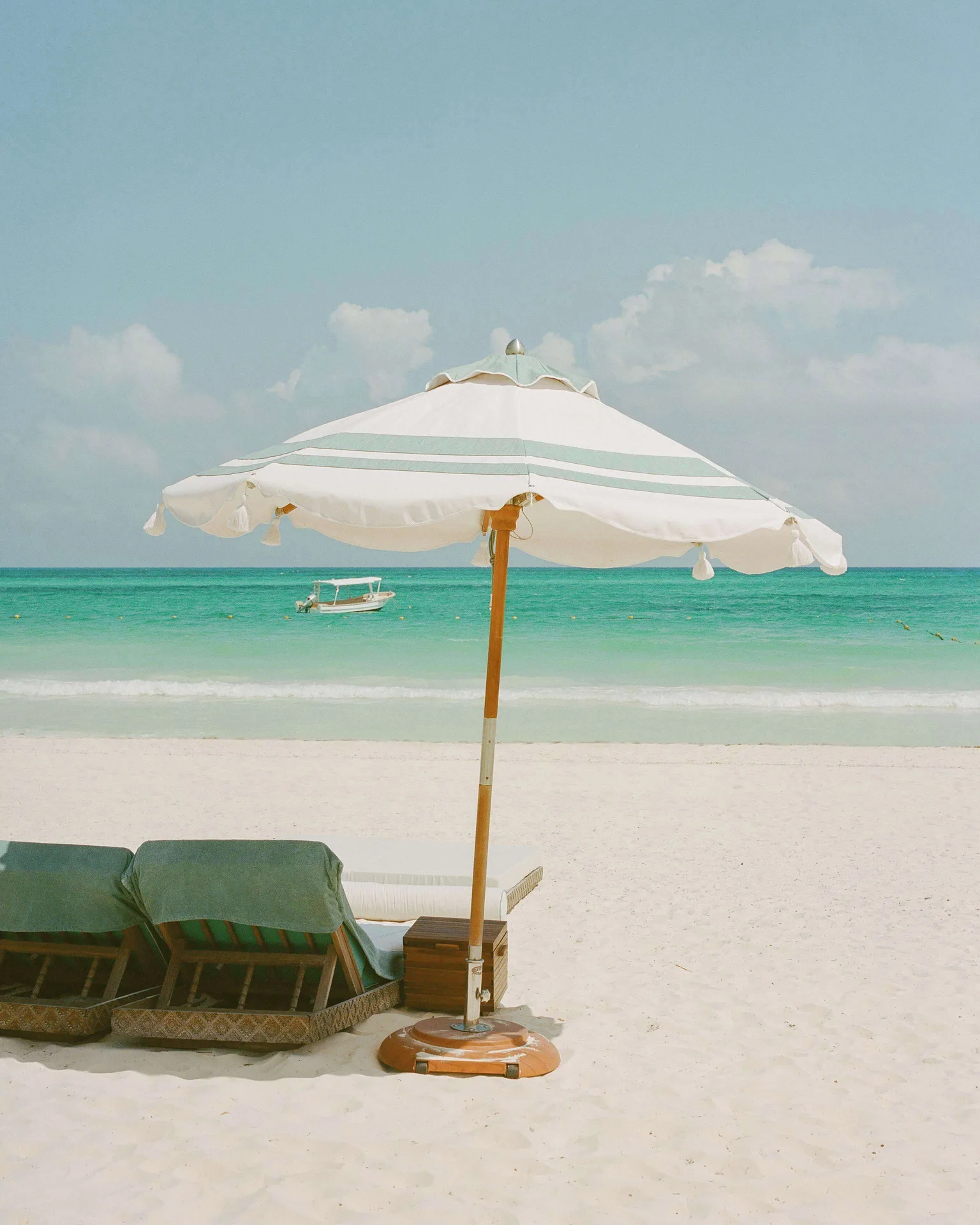 Beach loungers and umbrella on the sand at Maroma, Riviera Maya.