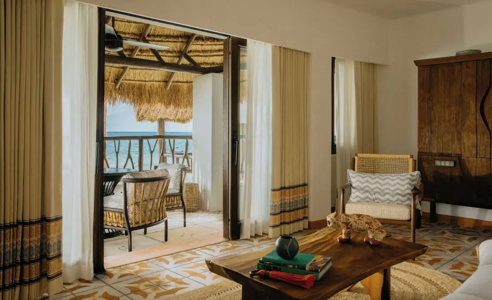 Oceanfront suite living room and thatched balcony at Maroma, Riviera Maya.
