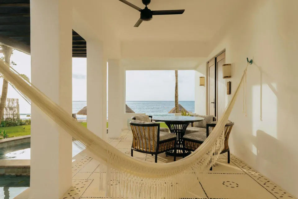 Oceanfront suite terrace with hammock and dining table at Maroma, Riviera Maya.