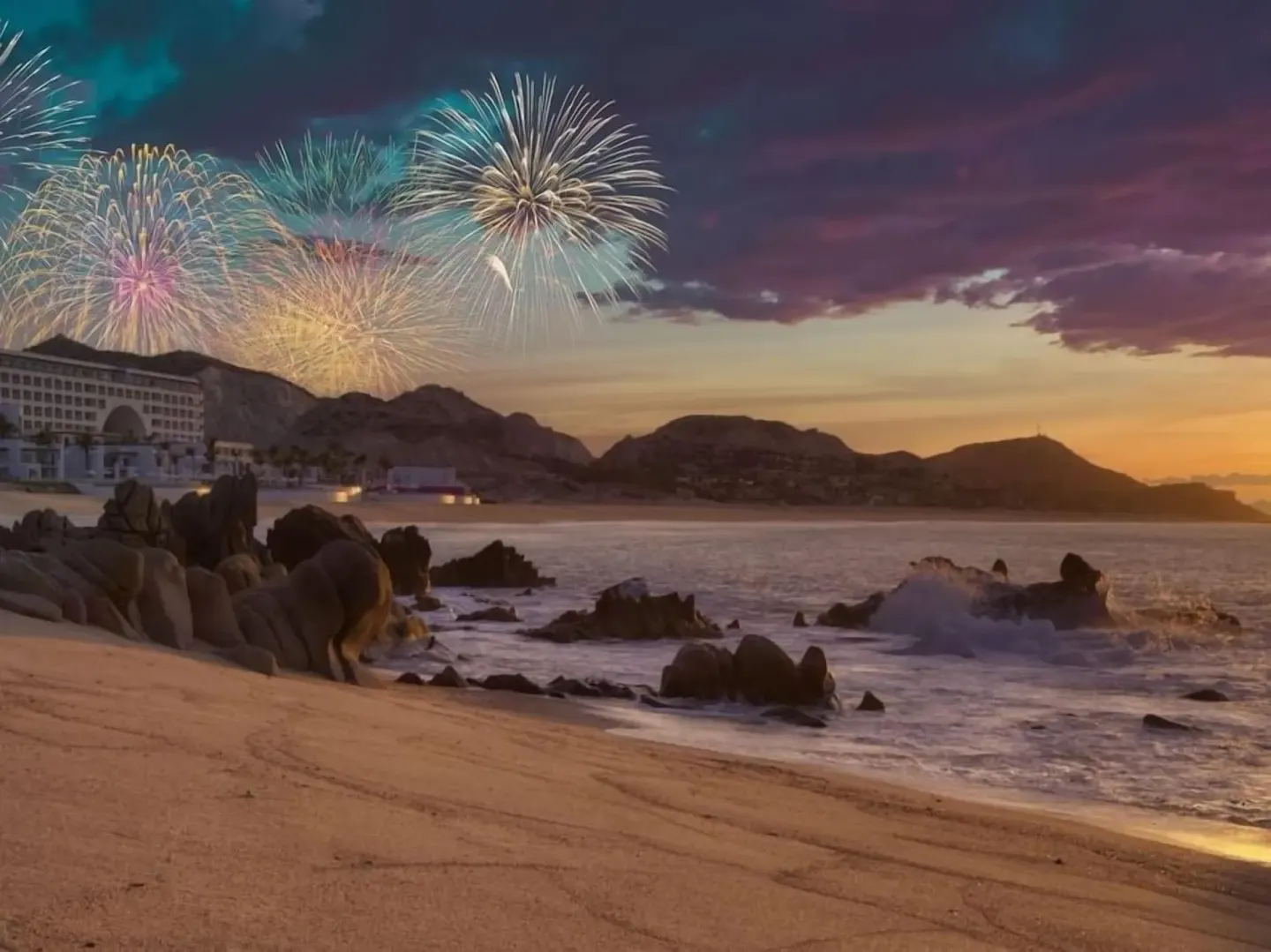 Fireworks light the beach and rocky shoreline at Marquis Los Cabos at sunset.