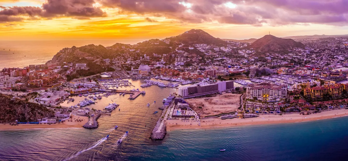 Aerial sunset view of the Cabo San Lucas marina and coastline near Marquis Los Cabos.