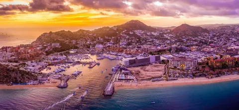 Aerial sunset view of the Cabo San Lucas marina and coastline near Marquis Los Cabos.