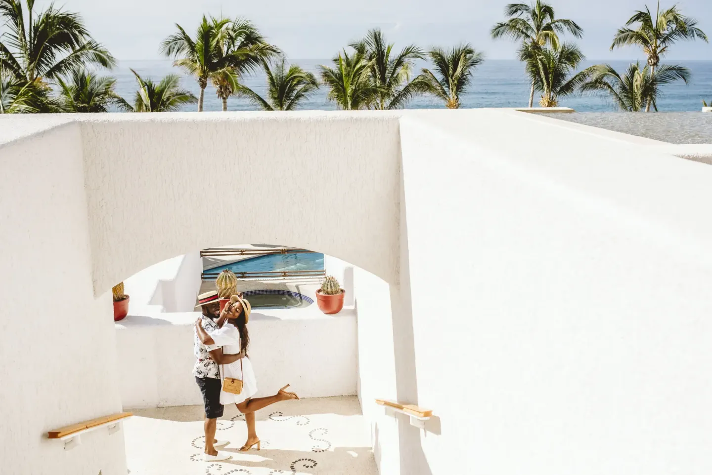 White stairway with ocean and palm trees beyond at Marquis Los Cabos.