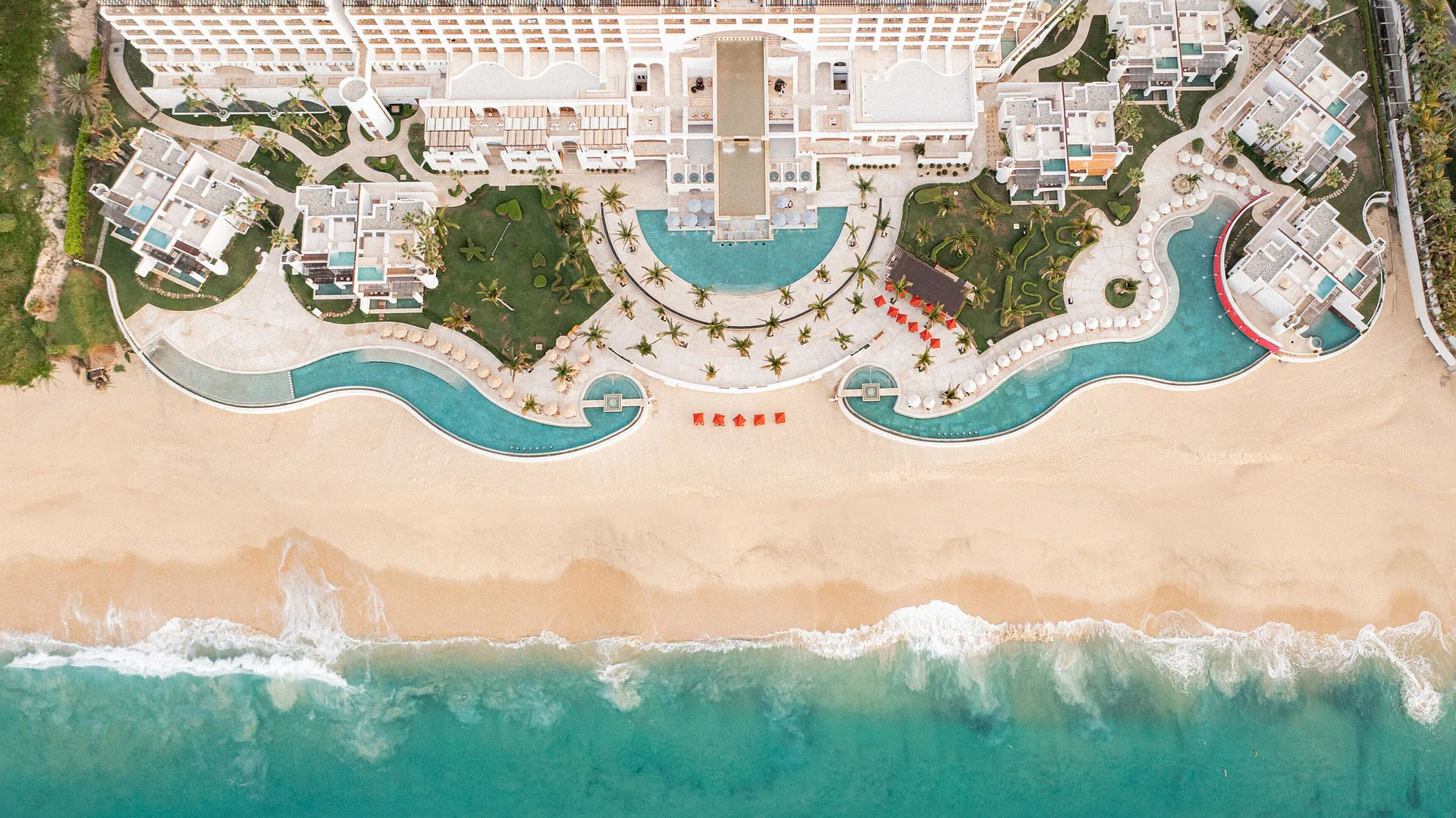 Top-down aerial view of the pools and beach at Marquis Los Cabos.